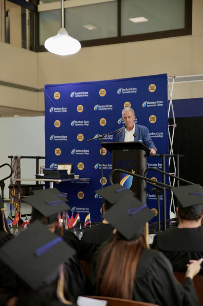 President Lane Glenn on stage giving opening remarks to the crowd at the CAE End-of-Year Celebration