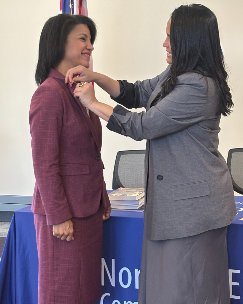 Celinas pins emblem to Naydeens jacket