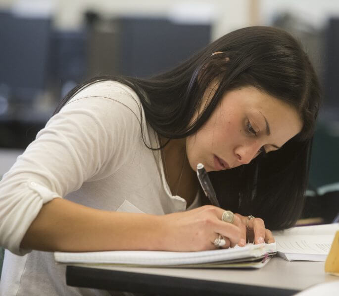 woman writing at desk