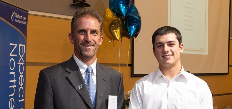 Lane Glenn next to a happy scholarship winner