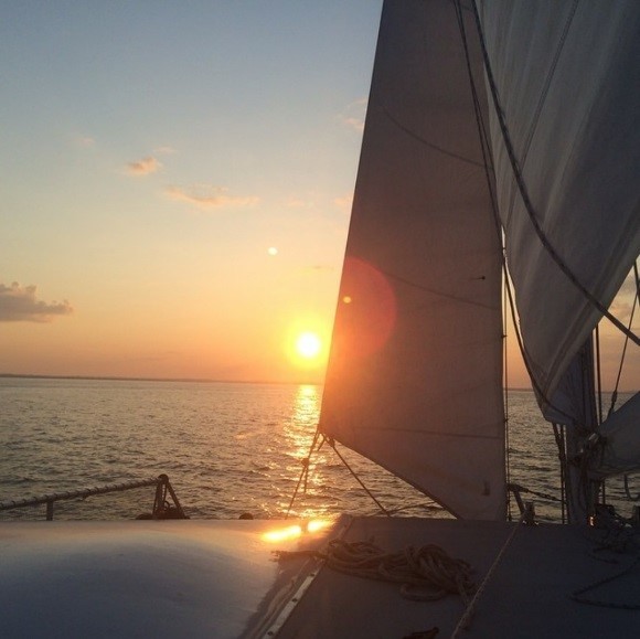 A sailboat on a lake at sunset