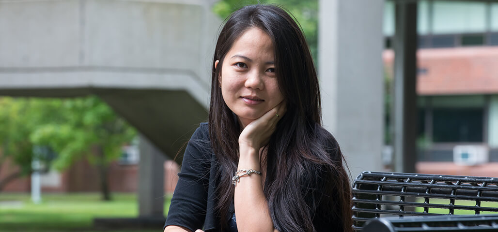 An Accounting student sitting at a table outside at the Haverhill Campus.