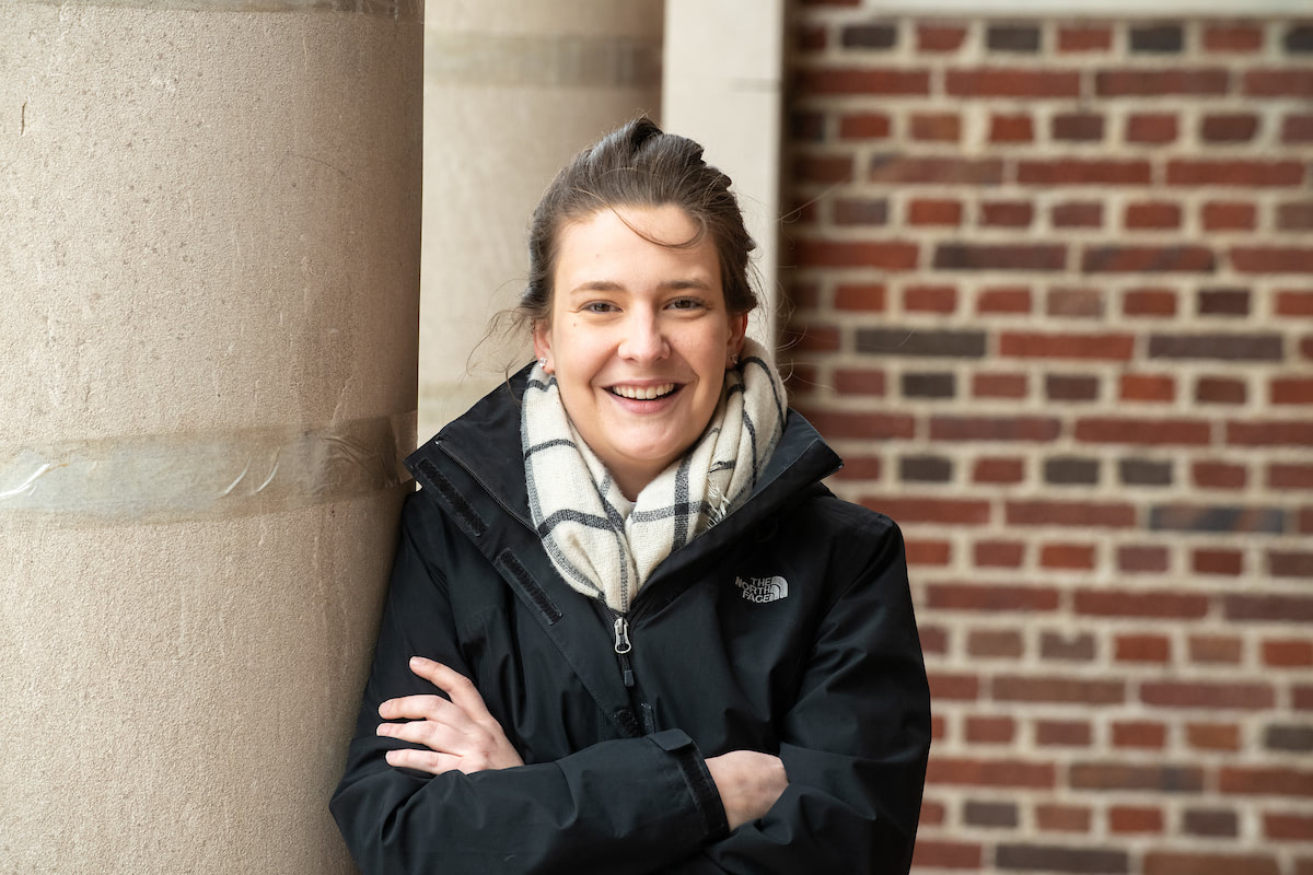 A portrait of NECC student Reanne Malesky against a brick wall