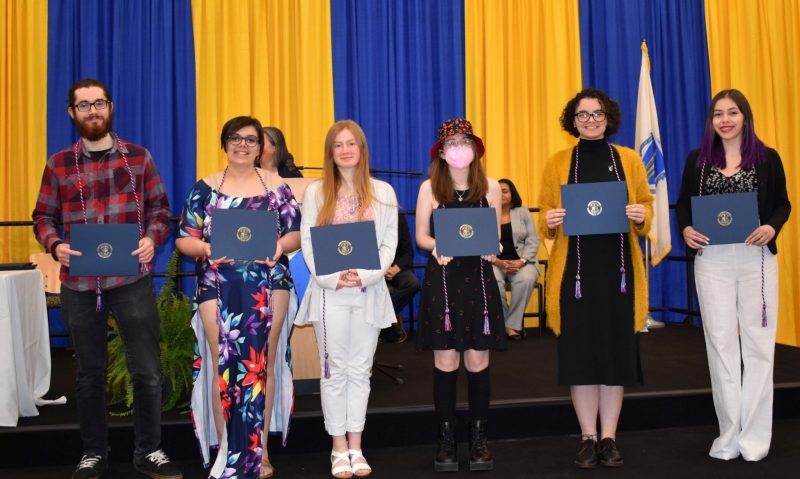 Six students with certificates