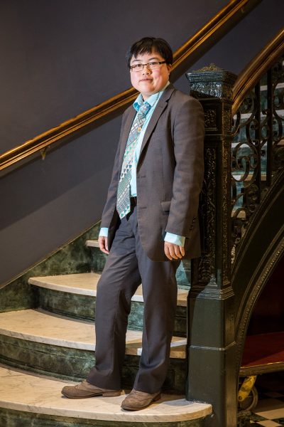 Lydia Brown standing on the bottom step of a marble staircase.