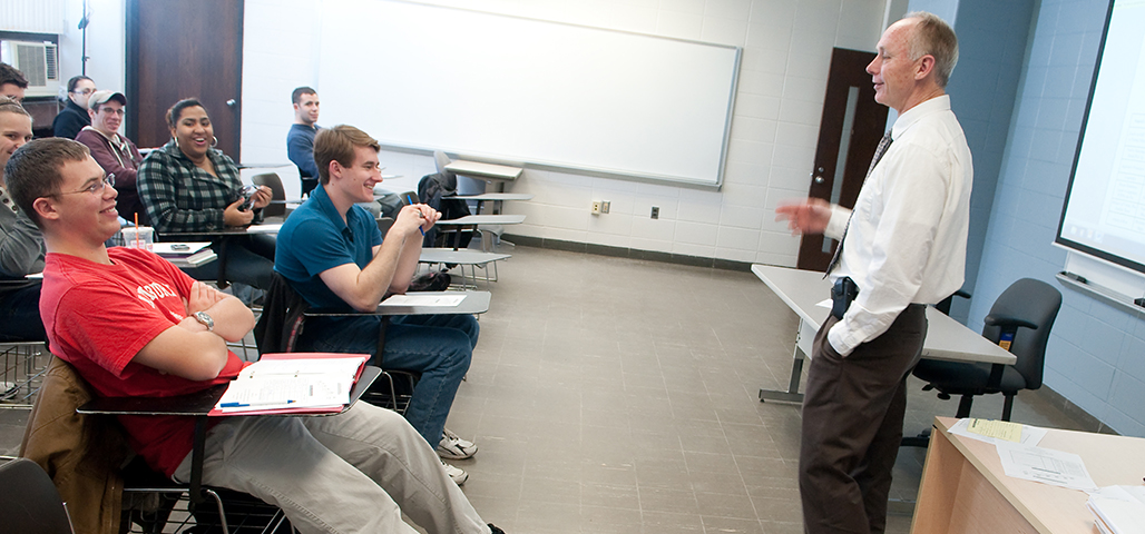 Professor Paul Cavan talking to a classroom of energetic and interested Criminal Justice Associate Degree students.