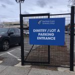 Large blue sign on the Dimitry / Lot A Parking Entrance walkway gate.