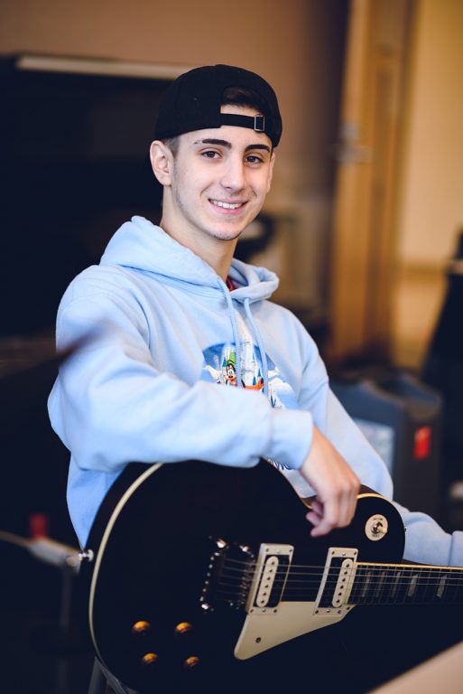 Andy Chaves, with a guitar in his lap