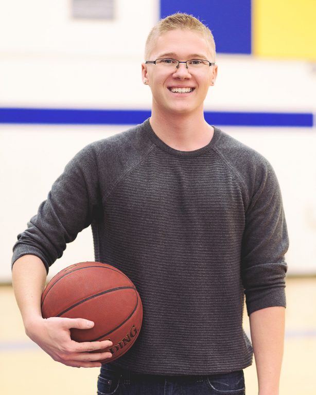 Connor Quinn, holding a basketball under his arm.