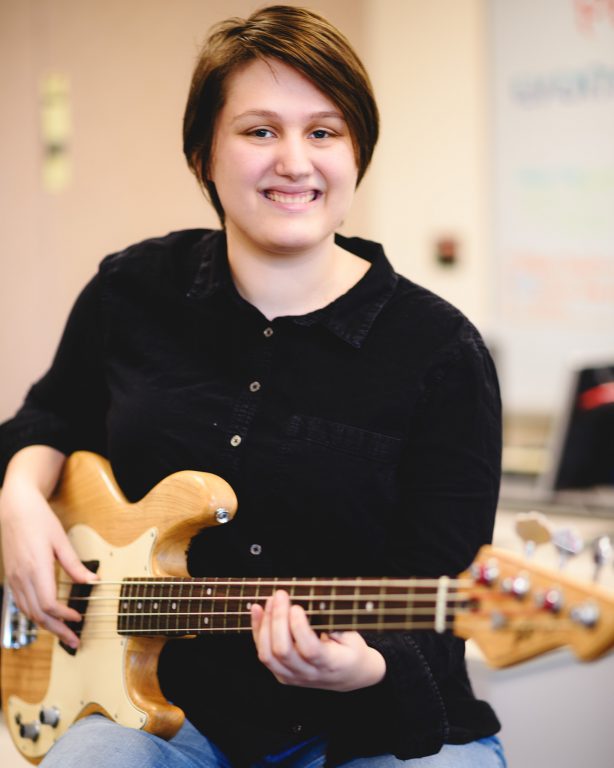 Haley Withrow, playing guitar