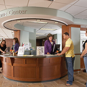 A student talks to a receptionist in NECC's one-stop center