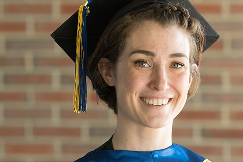 Nursing Grad, Allison Belisle smiles in her graduation cap and gown