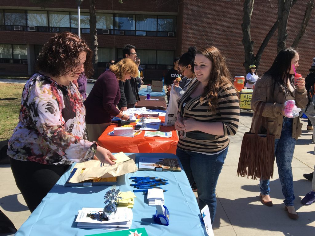 A student visits the GURC resource table at Spring Jam