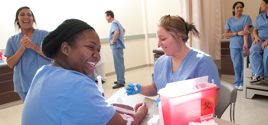 Students in the NECC Medical Assistant Certificate program practicing phlebotomy procedures.