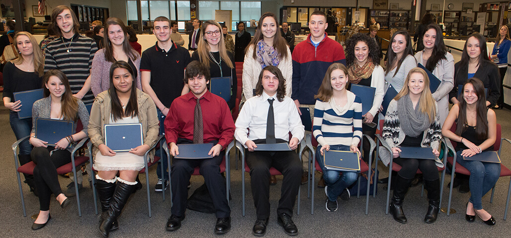 A group of 17 Early college students with their degrees.