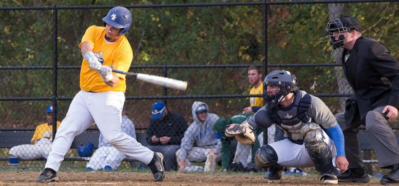 An NECC baseball player at bat at game