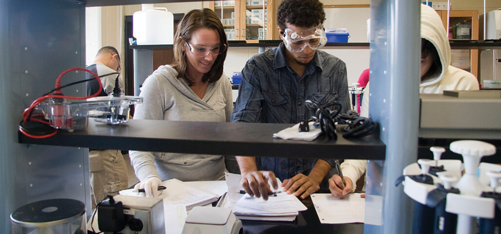 Two students working together in a stocked science lab